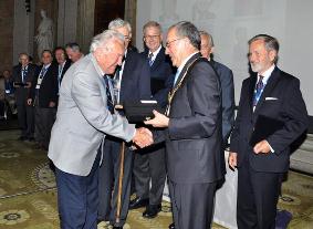 George Zarzycki being congratulated by President Orhan Altan on receiving an ISPRS Fellowship